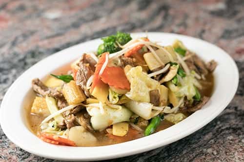 A veggie stir-fry with bean sprouts, bok choy, bamboo shoots, Mushrooms, green beans, broccoli, cabbage, carrots, & your choice of meat.