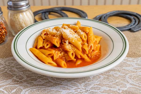 Classic penne pasta tossed in a rich tomato cream sauce and topped with grated Parmesan, served in a white-rimmed bowl with green trim.