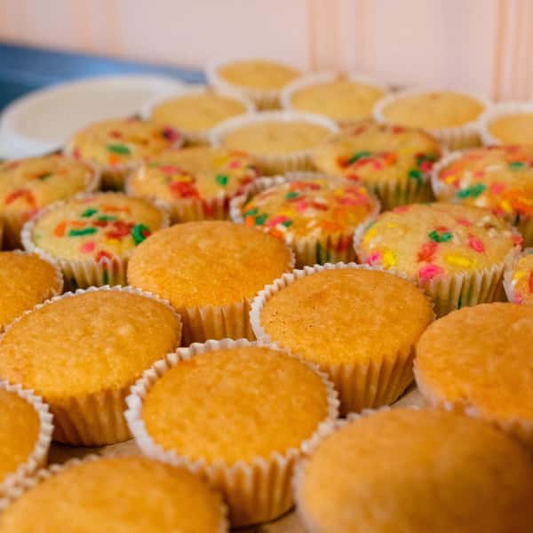 Unfrosted cupcakes on a baking tray