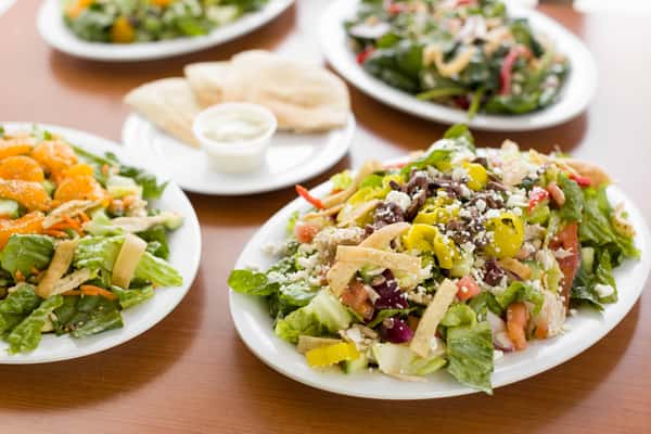 assorted salads and pita bread at chicken dijon in el segunado and renondo beach, ca