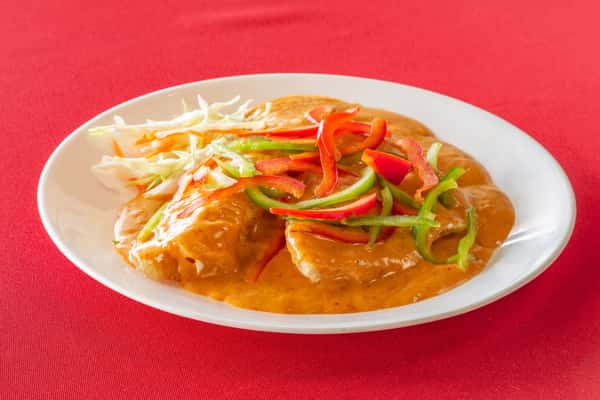 Grilled chicken breast topped with creamy orange curry sauce, shredded cabbage, and sautéed red and green bell peppers.