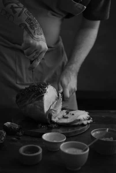 Chef cutting a ham