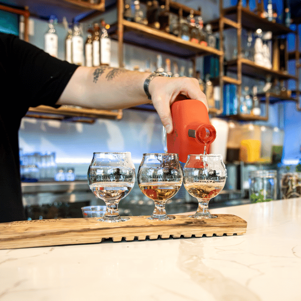 server pouring tequila flight