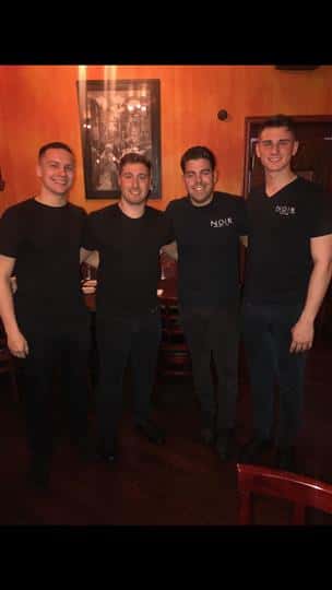 four servers posing together