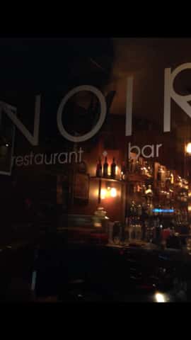the front door which says "Noir restaurant and bar"