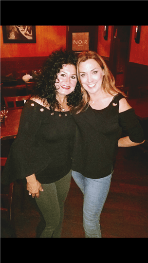 two women smiling and posing together