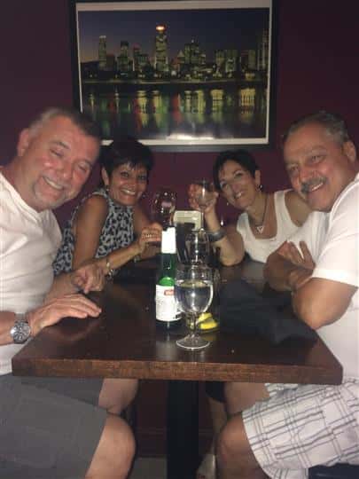 a group of four happy customers around a table