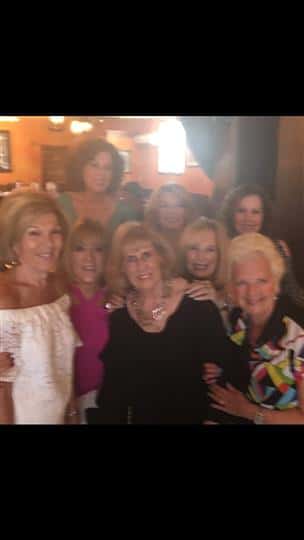 8 women smiling together