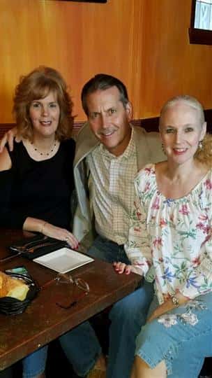 3 customers smiling and posing together