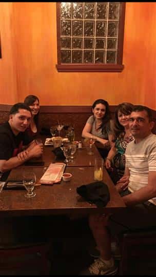 five customers smiling at their table