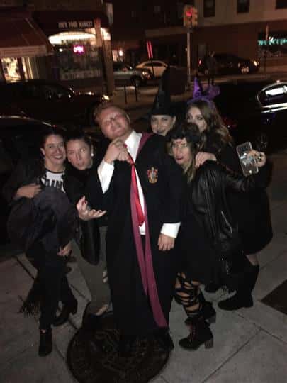 six customers posing outside the restaurant and dressed up for halloween