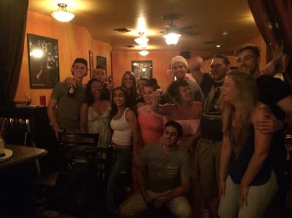 a big group of friends posing together before a night of fun