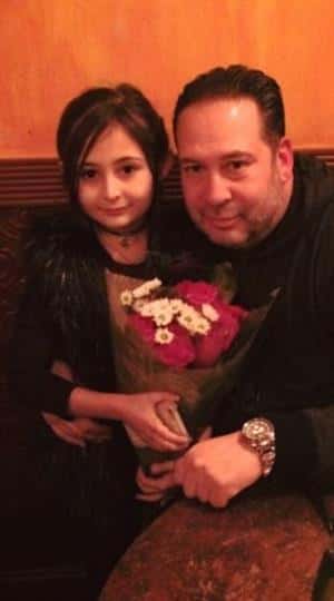 a dad and his daughter holding a bouquet