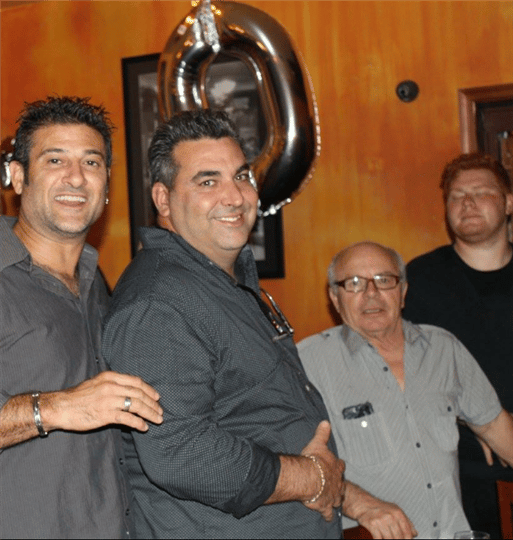 four customers smiling and posing