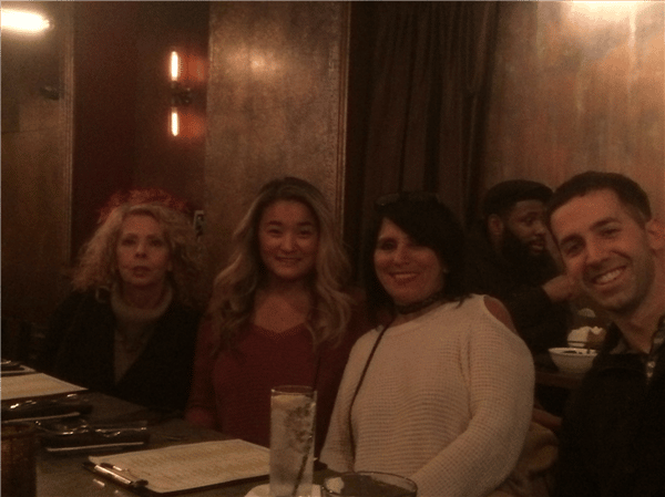 four customers smiling at the bar