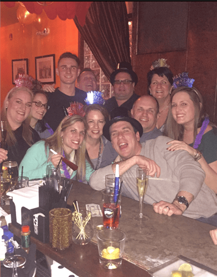 a group of smiling customers with happy new year attire