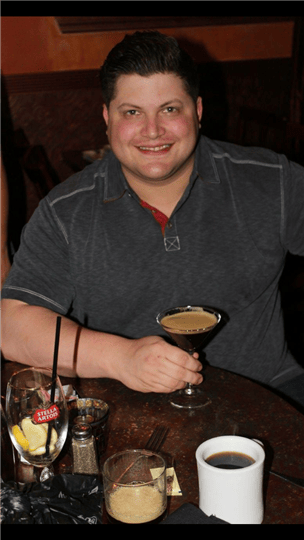 a customer smiling with his drink
