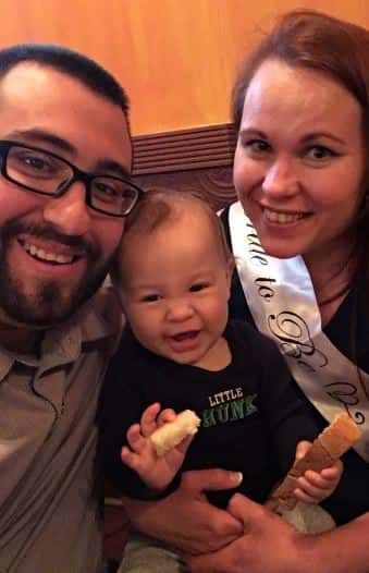 a couple posing with their baby