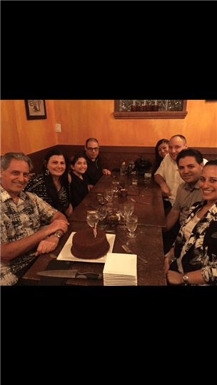 a table full of happy guests smiling
