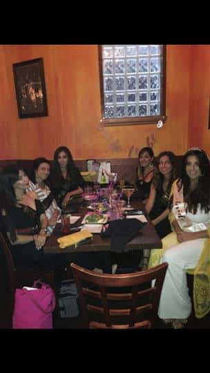 six customers smiling together with one being a bride to be at a bridal shower