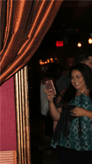 a girl taking a selfie on her phone