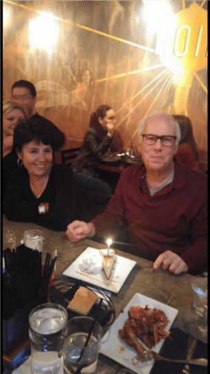 a customer with a slice of pie and a lit candle