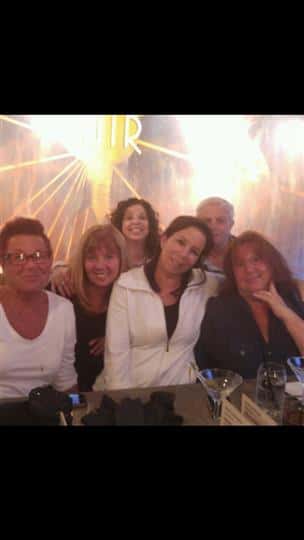 a group of seven friends smiling together