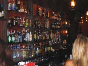 bar area with many liquor bottles shown