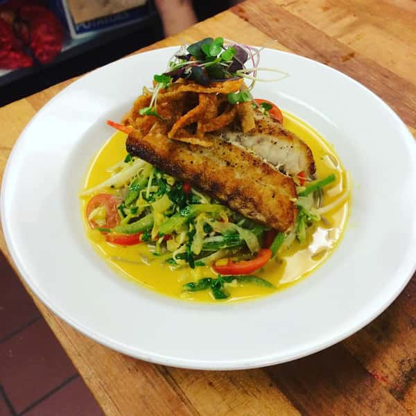 Gulf of maine salmon, mixed greens, local tomatoes, cucumbers, pickled onions and fresh corn puree