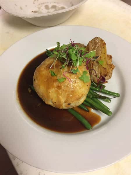 Roasted chicken over string beans and gravy