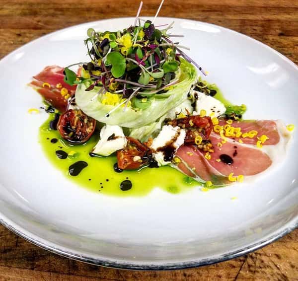 Italian Prosciutto, Roasted Tomatoes, Fresh Mozzarella, Basil Oil, Saba Dressing, and Shaved Salt Cured Egg Yolk