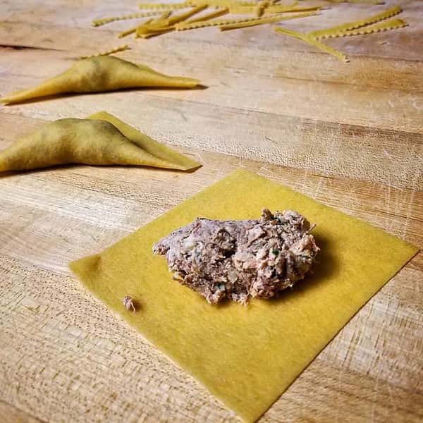 Ravioli filled with Brisket, wild mushrooms, ricotta, goat cheese, and rosemary