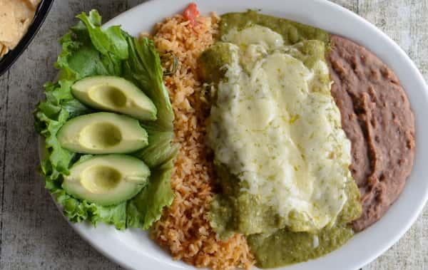 Traditional Mexican combination plate with rice, beans, guacamole, and avocado.