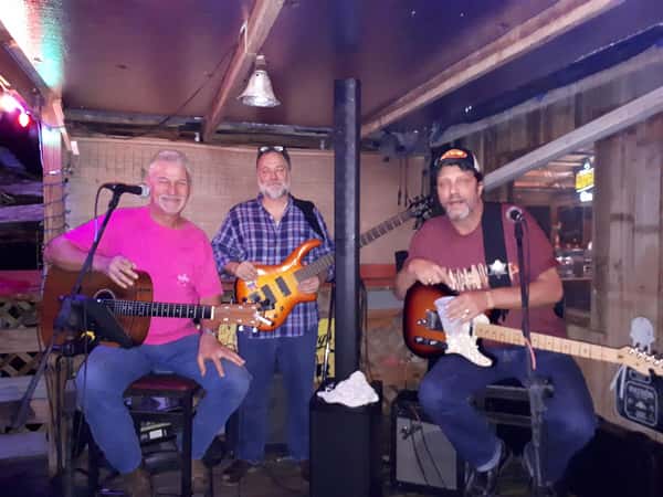 band with instruments posing for photo