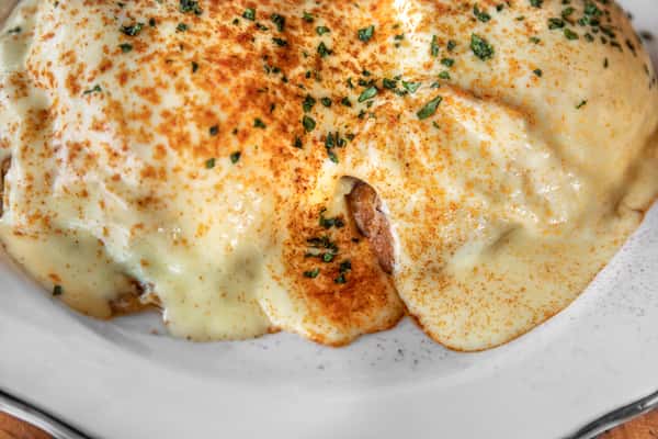 Seasoned pineapple hollandaise runs down over our eggs benedict