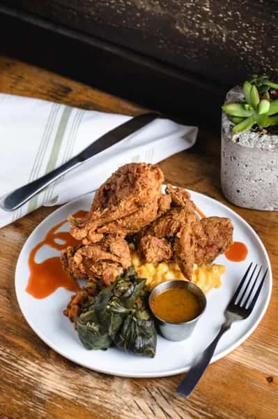 Crispy chicken served with a sauce and a side