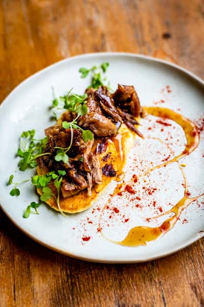 Meat dish with a sauce over and garnish on top