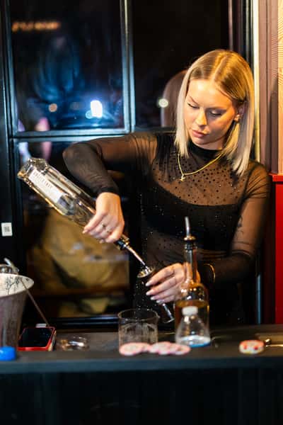 Skilled bartender crafting artisanal cocktails at The Kennedy's sophisticated bar