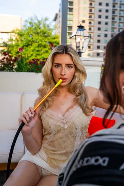 Elegant guest enjoying premium hookah service at The Kennedy's exclusive lounge area