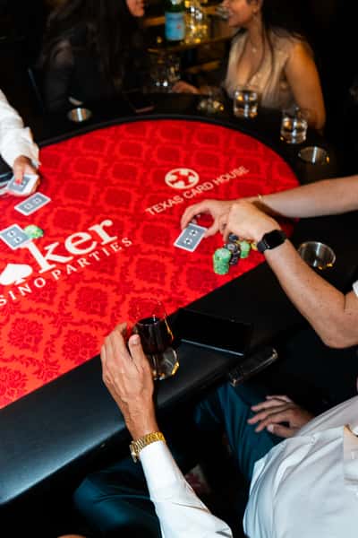 Guest engagement activity featuring red gaming cards at The Kennedy entertainment event