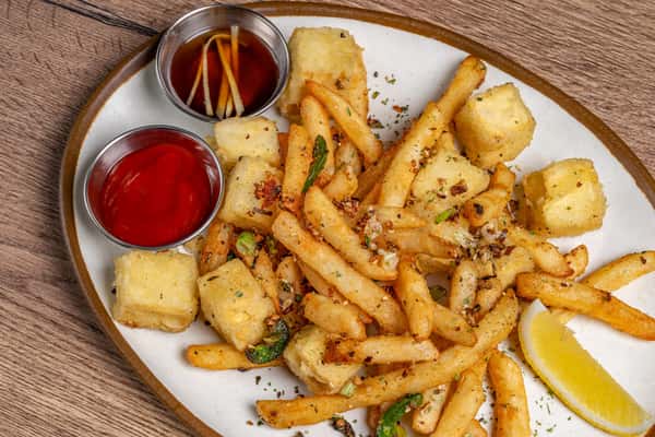 Garlic seasoned fries and crispy tofu cubes served with ketchup, soy dipping sauce, and a wedge of lemon.