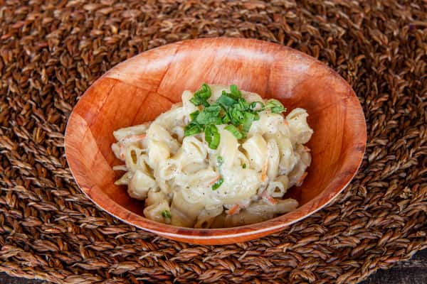 Side portion of Hawaiian macaroni salad at Kalei's Kitchenette, served with plates in San Diego