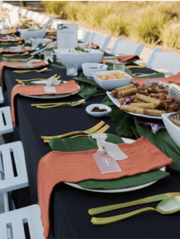 Place settings on a table for a Hawaiian themed event