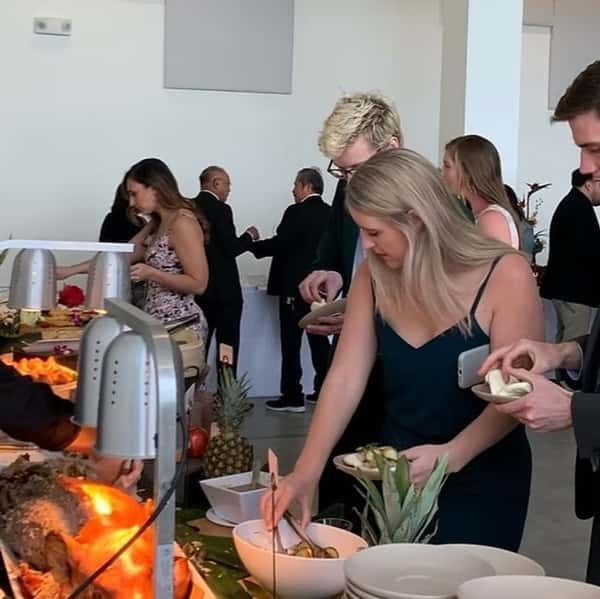 Guests picking up food from a buffet line