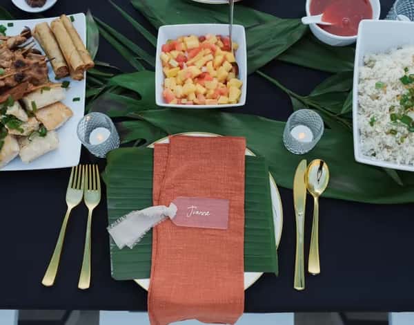 A table place setting with food served family style on a table