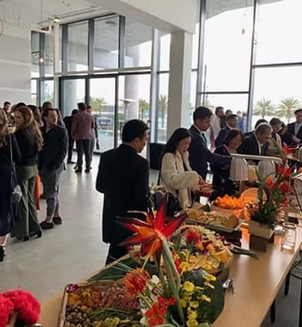 Guests standing in a buffet line at a catered event