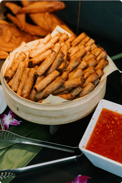 A steamer basket filled with fried lumpia
