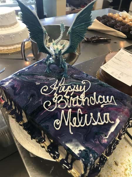 A cake with a dragon on top