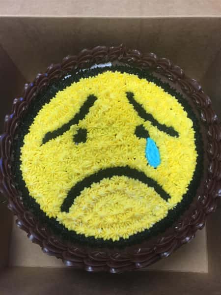 a crying emoji shaped cake