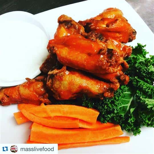 buffalo wings on a plate with dipping sauce